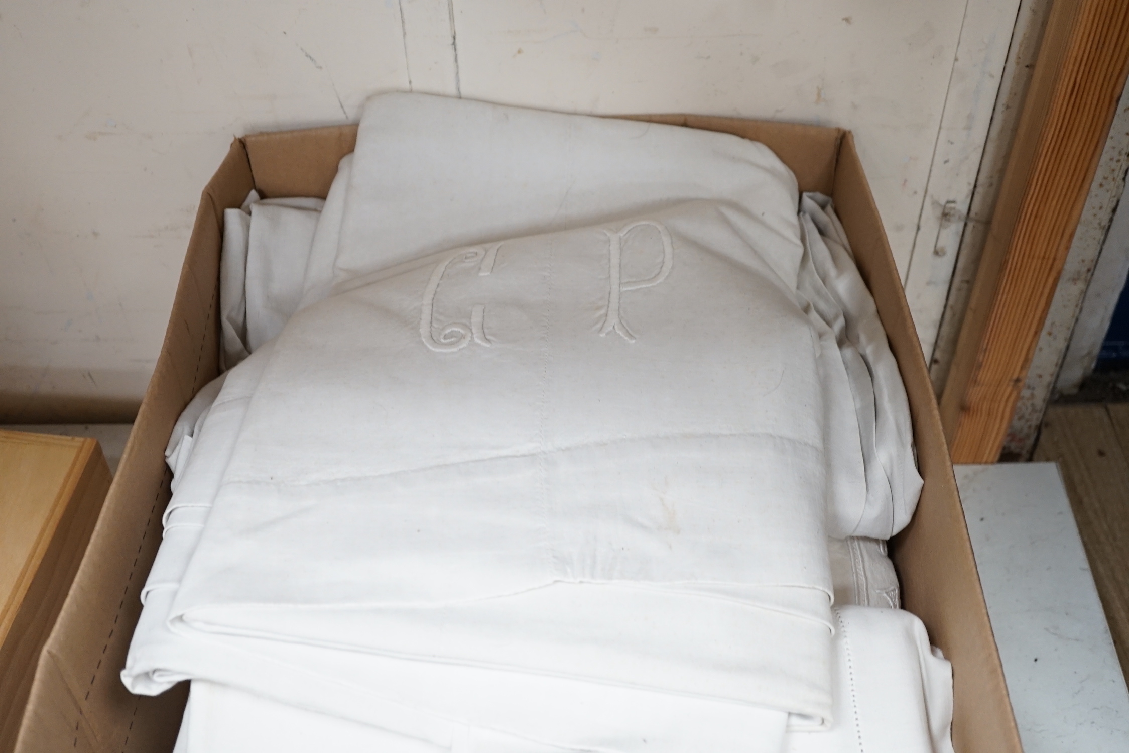 Twelve coarse woven, mostly monogrammed sheets